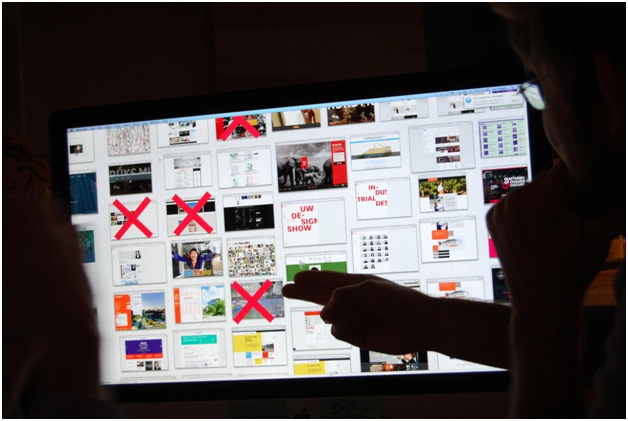 Photo showing people choosing different elements and styles for a web design creative direction.